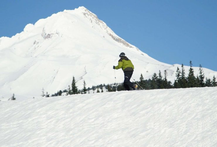 Still from Providence video of man snowshoeing past Mt. Hood
