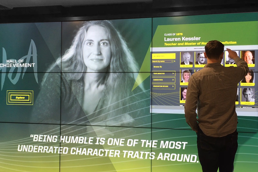 Person interacting with Hall of Achievement video wall